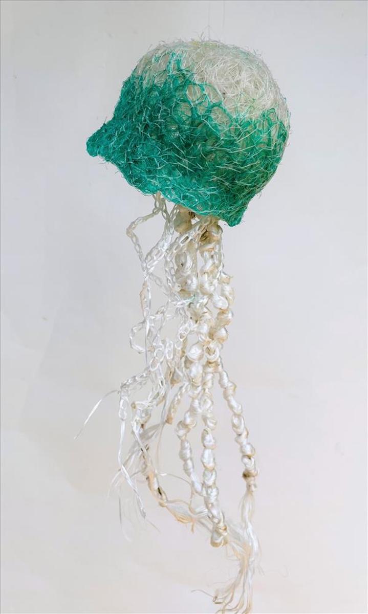 Sculpture of a turquoise and white jellyfish made from reclaimed fishing nets