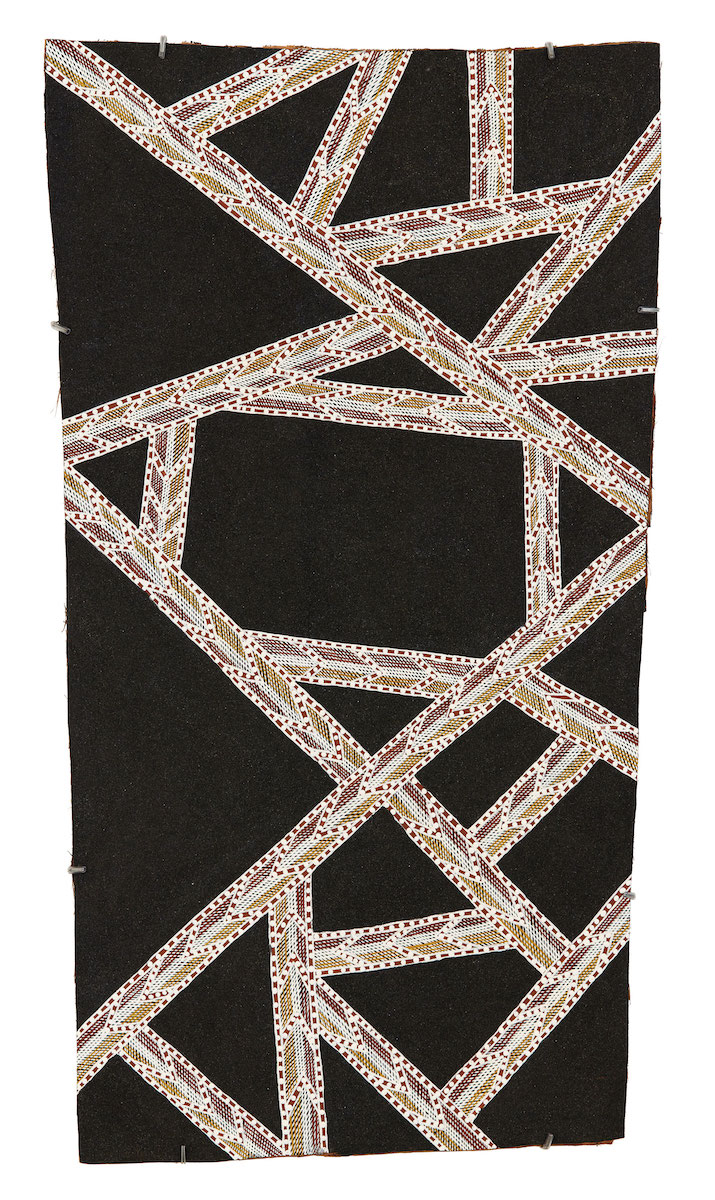 Abstract painting on bark with a shimmering black sand background overlaid with geometric triangular lines composed of yellow, red and white patterning.