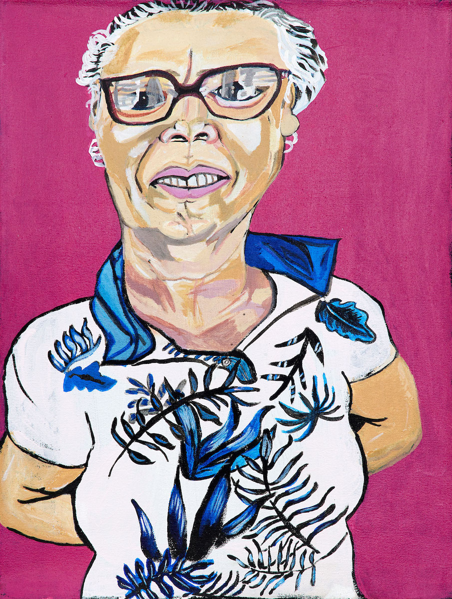 Portrait of a person wearing glasses and a floral blue and white shirt with their hands behind their back, on a pink background