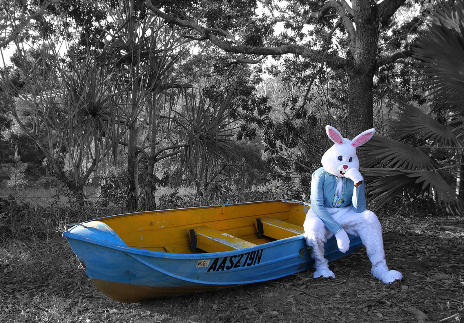 Life-sized Easter bunny sitting on a boat in the bush.
